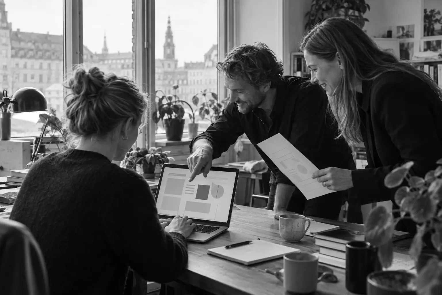 Illustration: three colleagues looking at a laptop together while one of them points at the screen