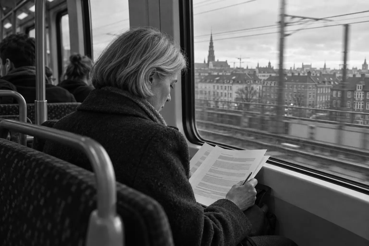 Illustration of a person reading printed pages with a pencil on a commuter train